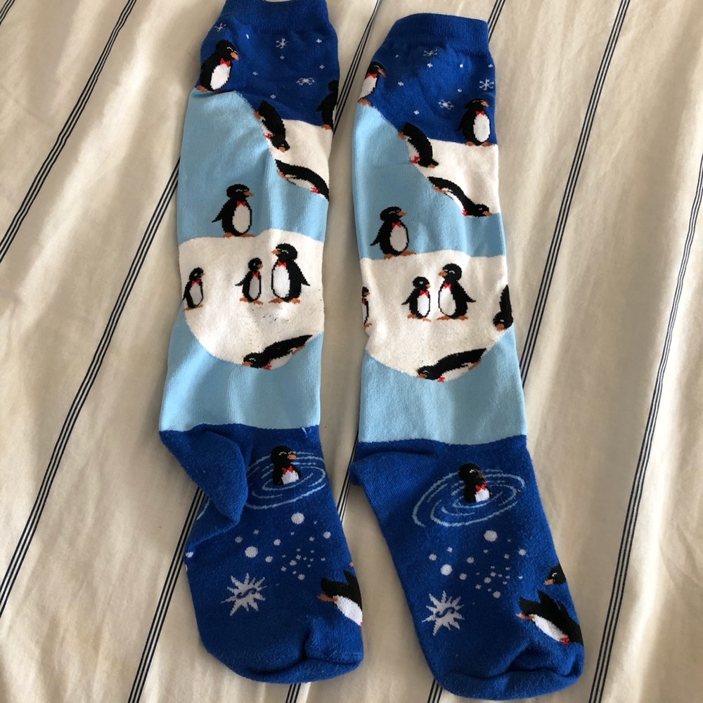 Fun penguins diving into water socks ice berg